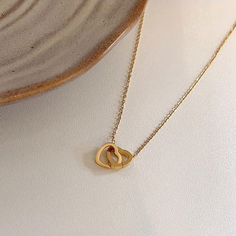 Close-up of intertwined gold hearts on Amour Eclatant Necklace