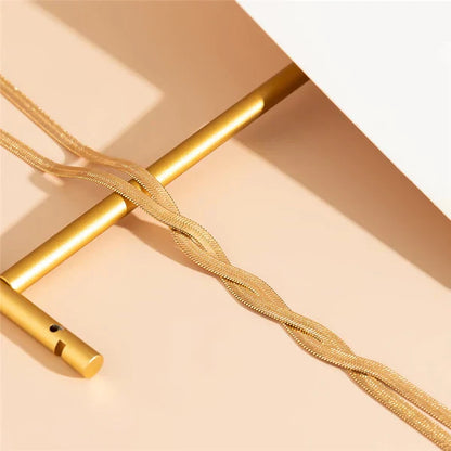 Close-up of the Soyeux Necklace in gold, highlighting its smooth finish