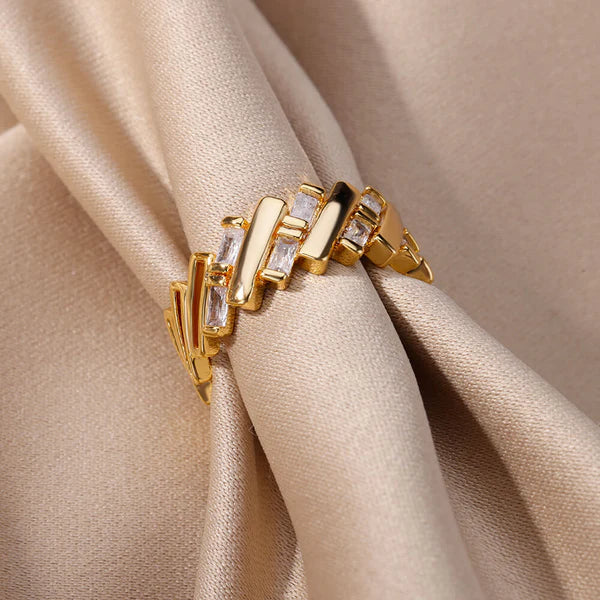 Elegant gold ring displayed on a velvet stand