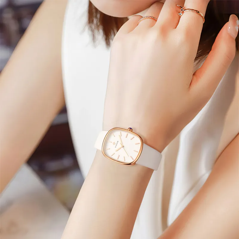 Elegant rose gold watch displayed on a wooden stand